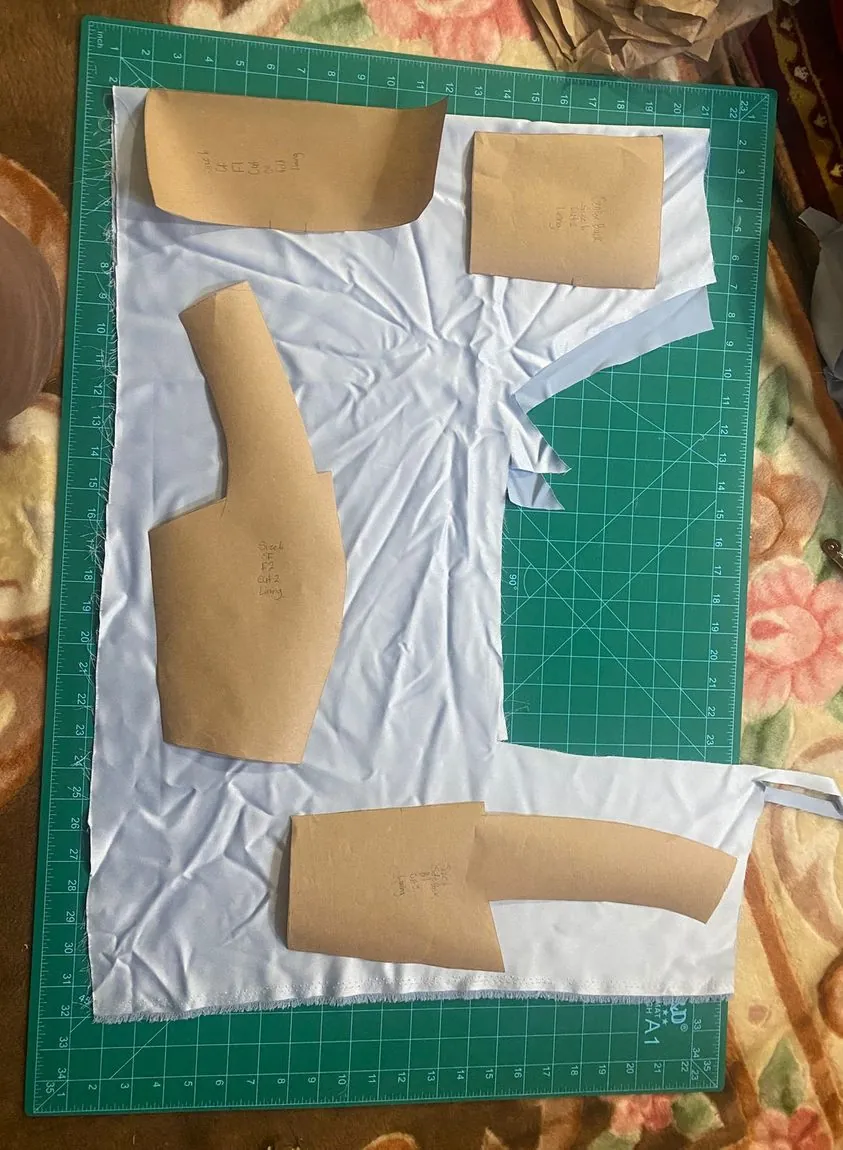 Hand-drafted paper patterns on the cutting mat